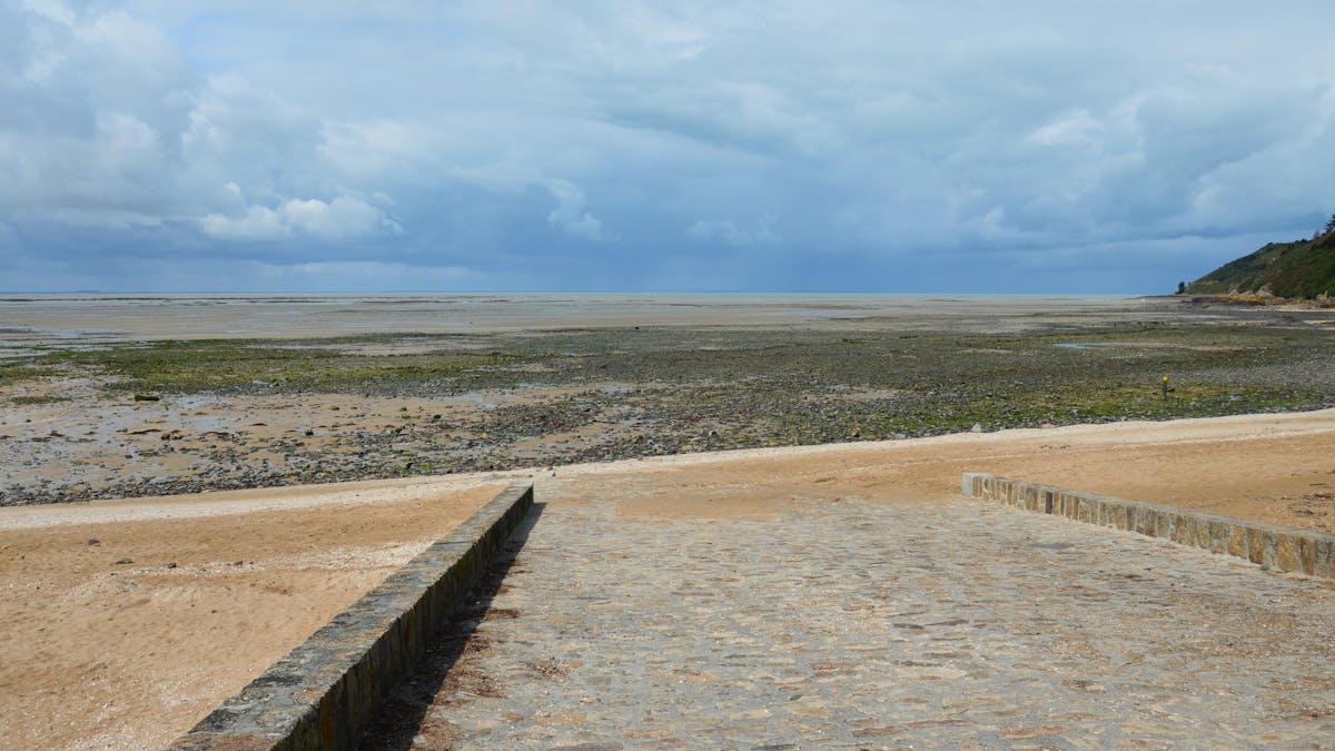 Beach Day Trips from Paris: Perfect Getaways for Sunseekers 1 Beach day trips from Paris - Normandy coast scenic beach with cliffs and golden sand
