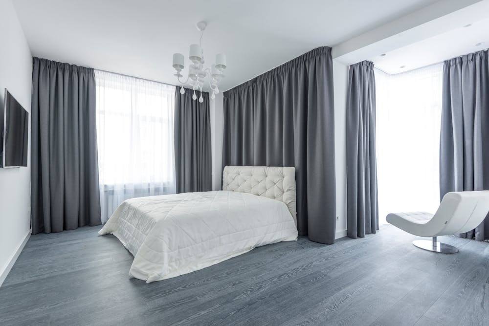 floor-length linen curtains in light-filled bedroom