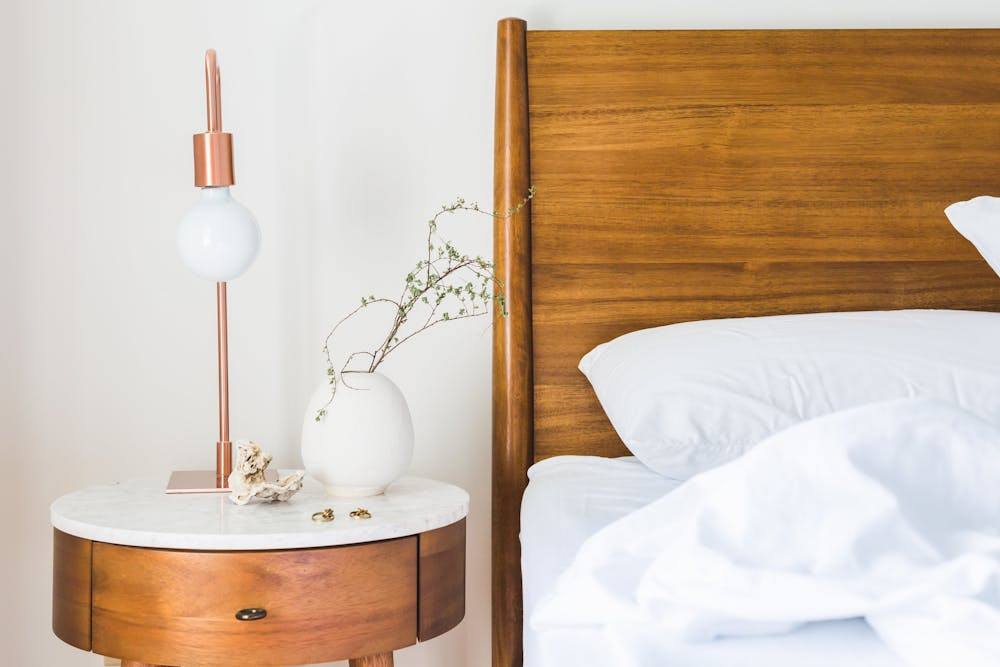 minimalist wood nightstand with soft reading lamp
