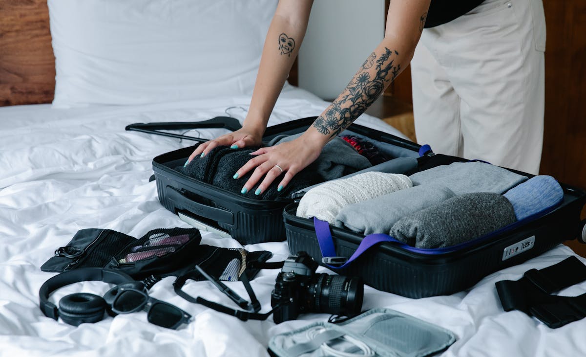 What to pack for Paris in April - stylish travel outfit and suitcase with Eiffel Tower backdrop