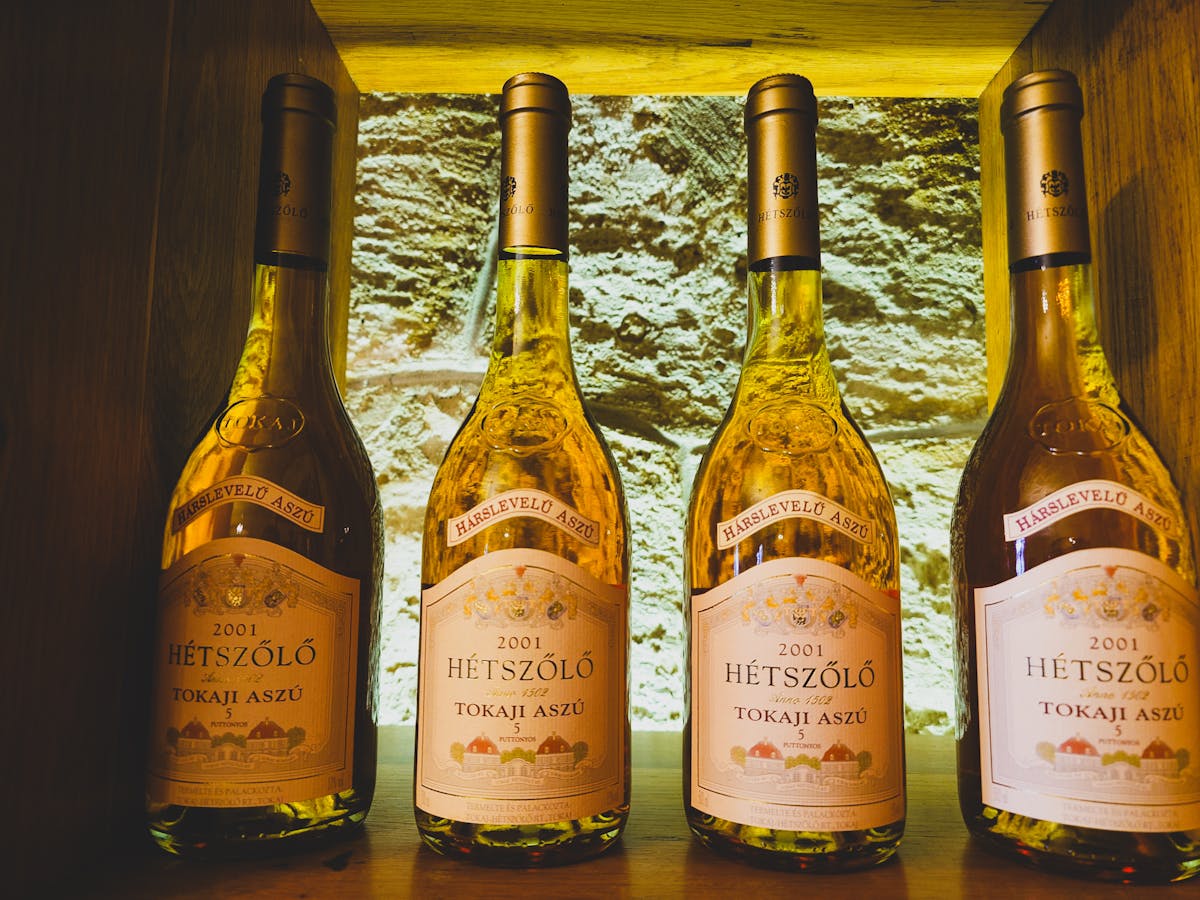 Four bottles of 2001 Hetszolo Tokaji Aszu wine in a cellar display.