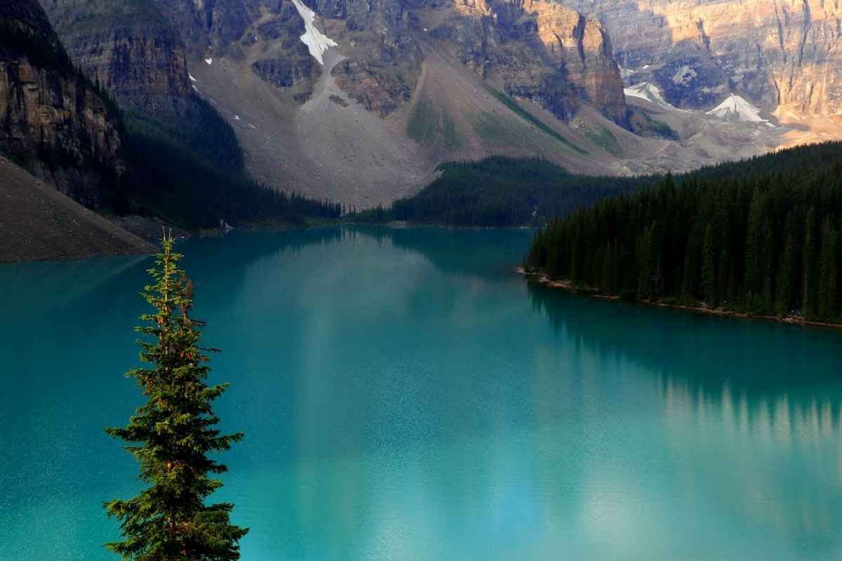 Scenic landscape of Moraine Lake surrounded by rugged mountains and vibrant blue waters in Banff National Park.