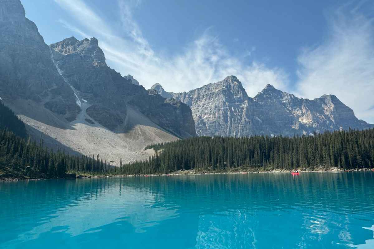 Breathtaking view of Moraine Lake with turquoise waters and the Canadian Rockies in the background.