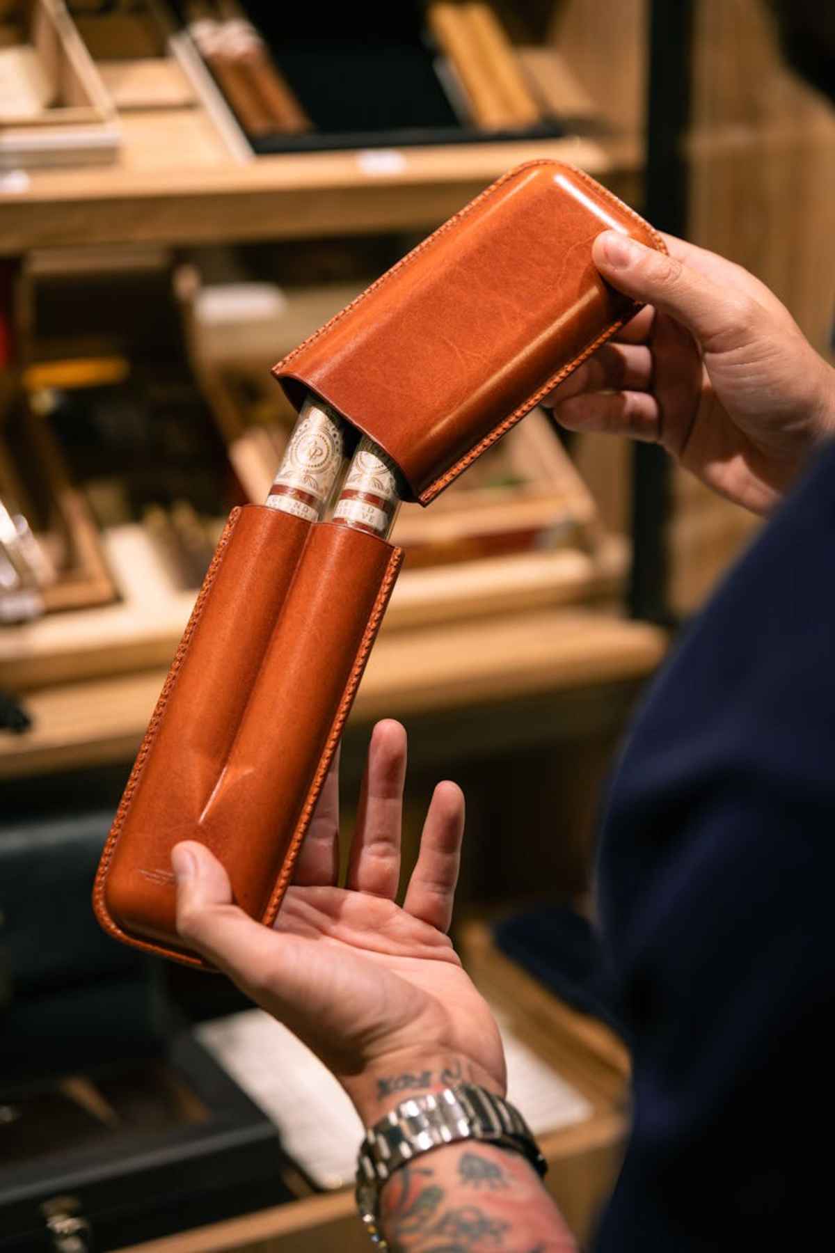 Hands holding premium cigars in a luxury leather case elegance style