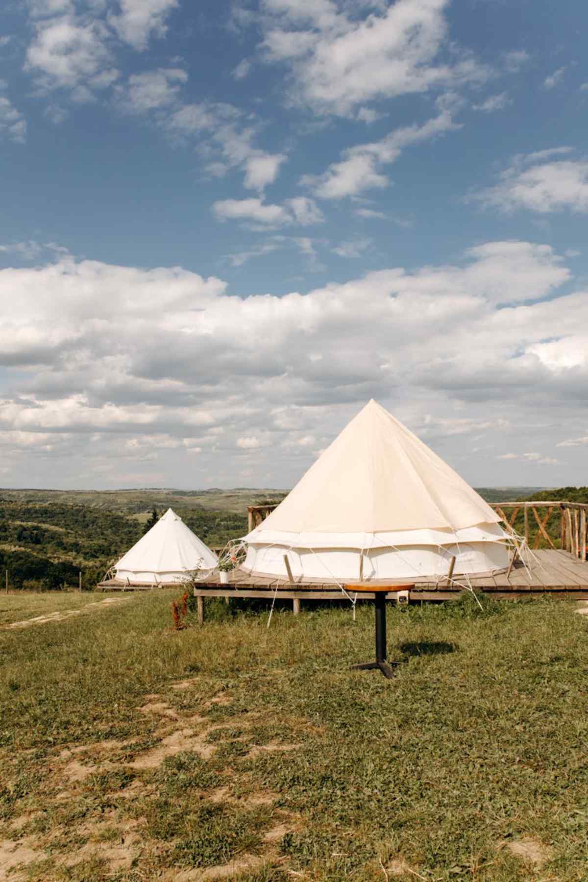 Beautiful glamping tents in picturesque countryside landscape