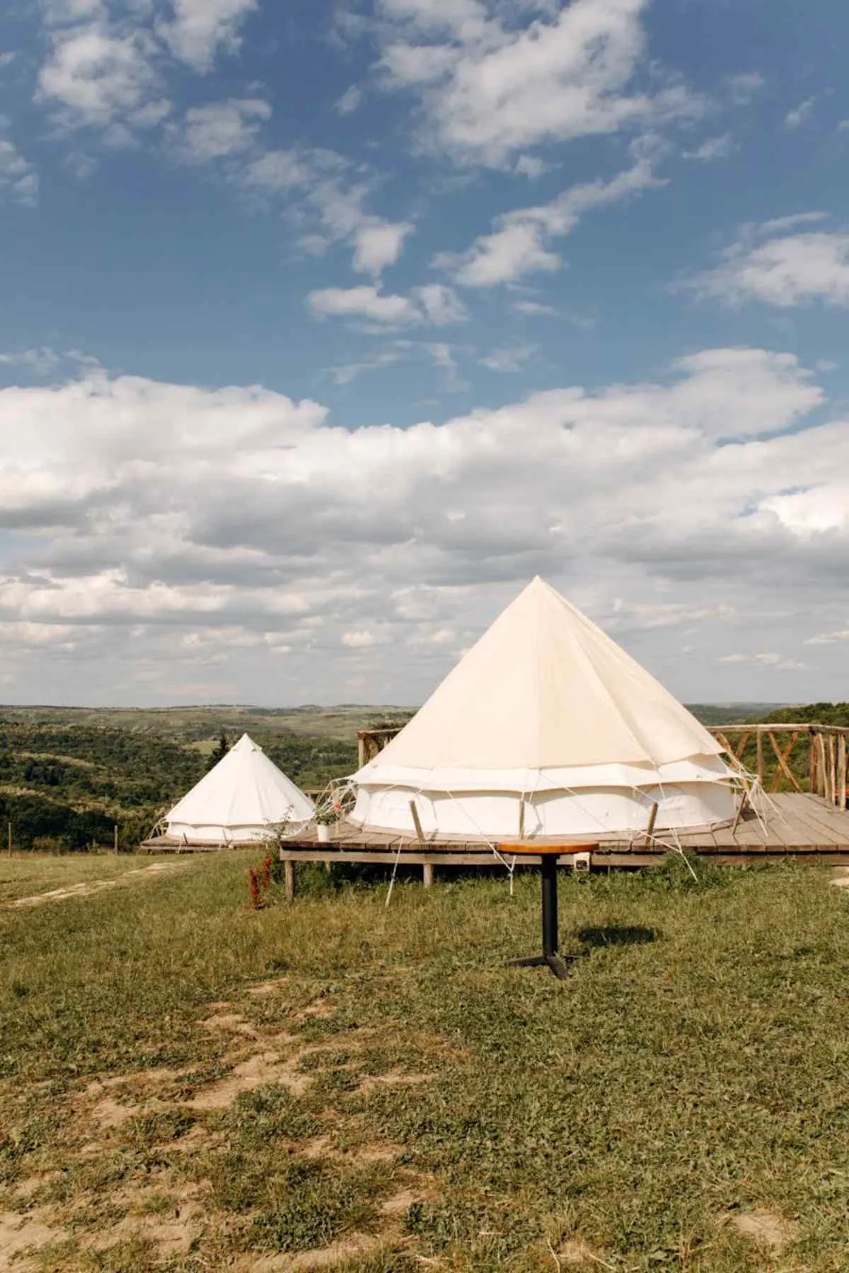 Beautiful glamping tents in picturesque countryside landscape