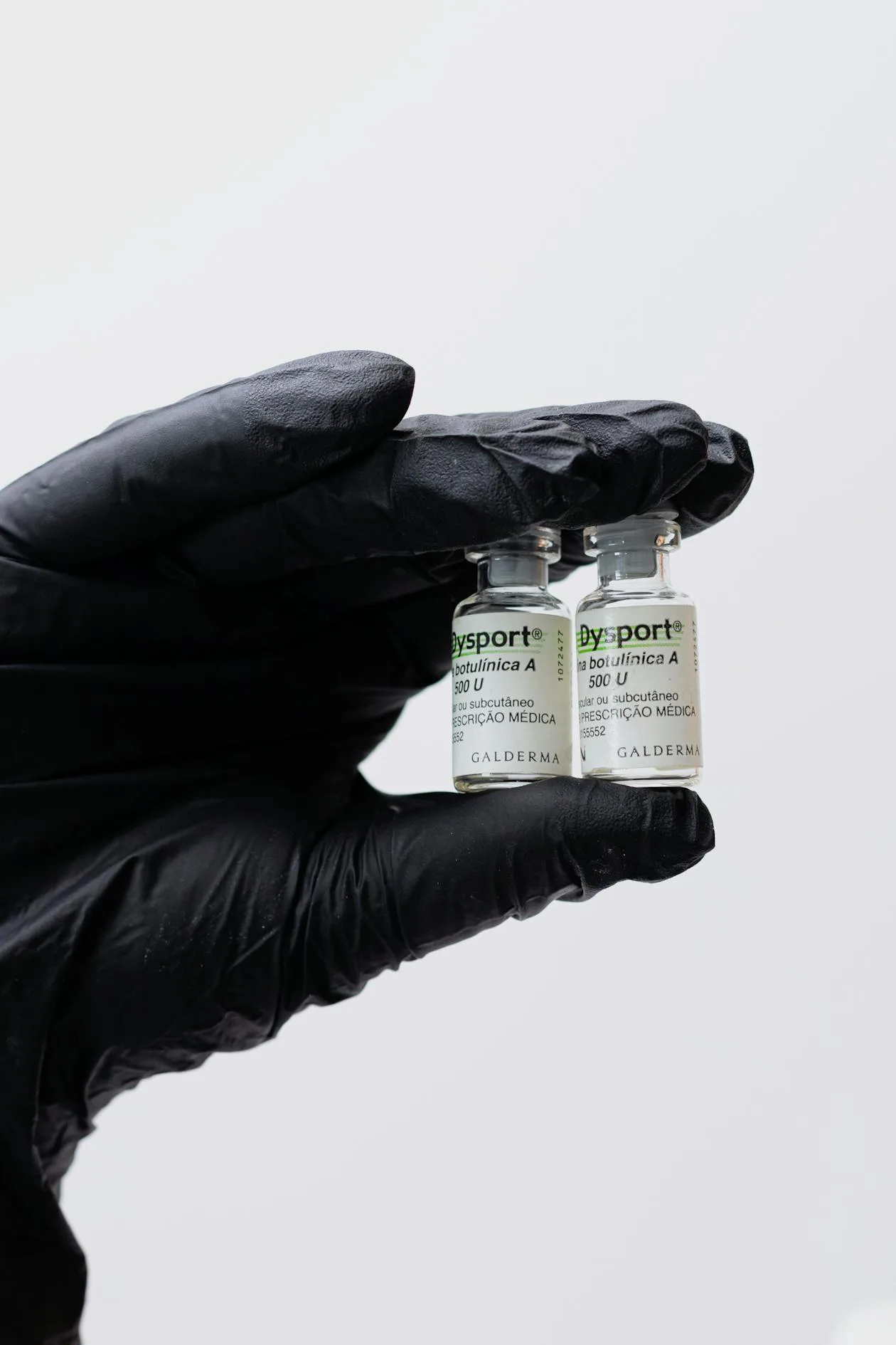 Best injectable peptides for anti-aging - medical vials in gloved hand