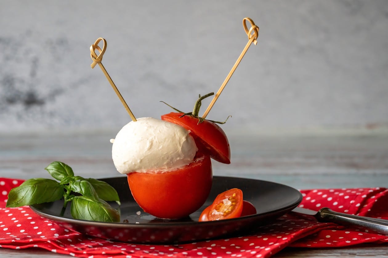 Caprese skewers assembled with cherry tomatoes, fresh mozzarella and basil on a stylish serving platter