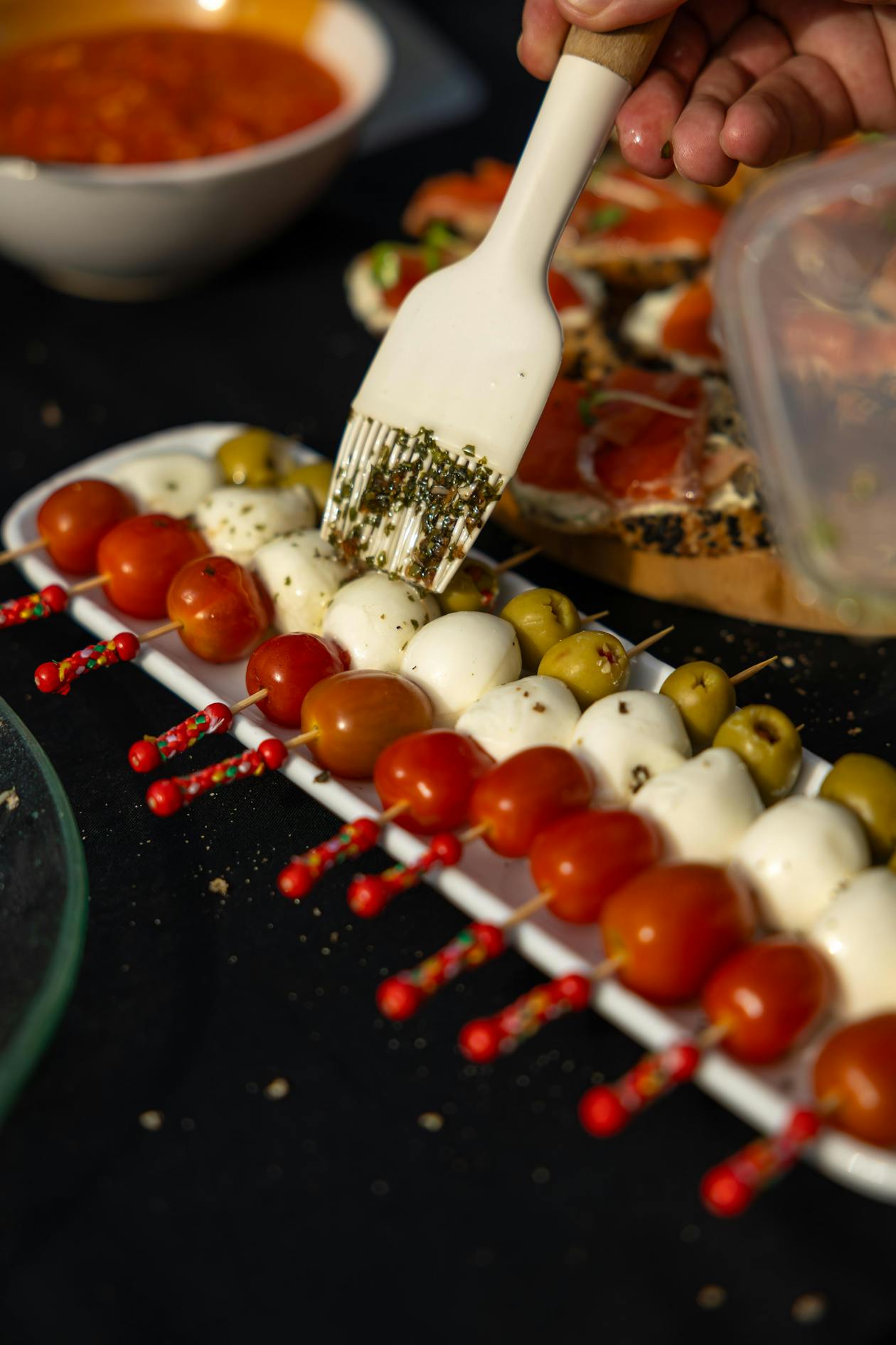 Elegant caprese skewers with cherry tomatoes, mozzarella and fresh basil drizzled with olive oil