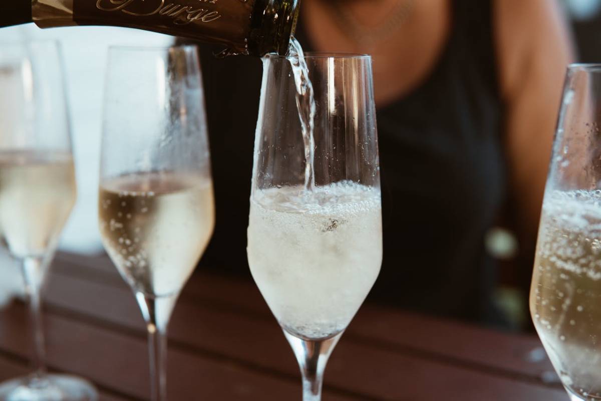 champagne being poured into a flute glass for sparkling wine storage tips
