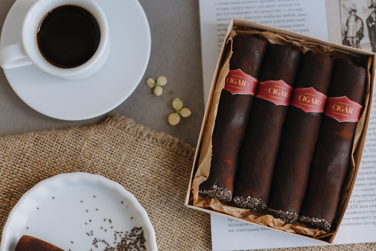 Top view of a coffee cup with chocolate cigars on a table for a relaxed gourmet setting