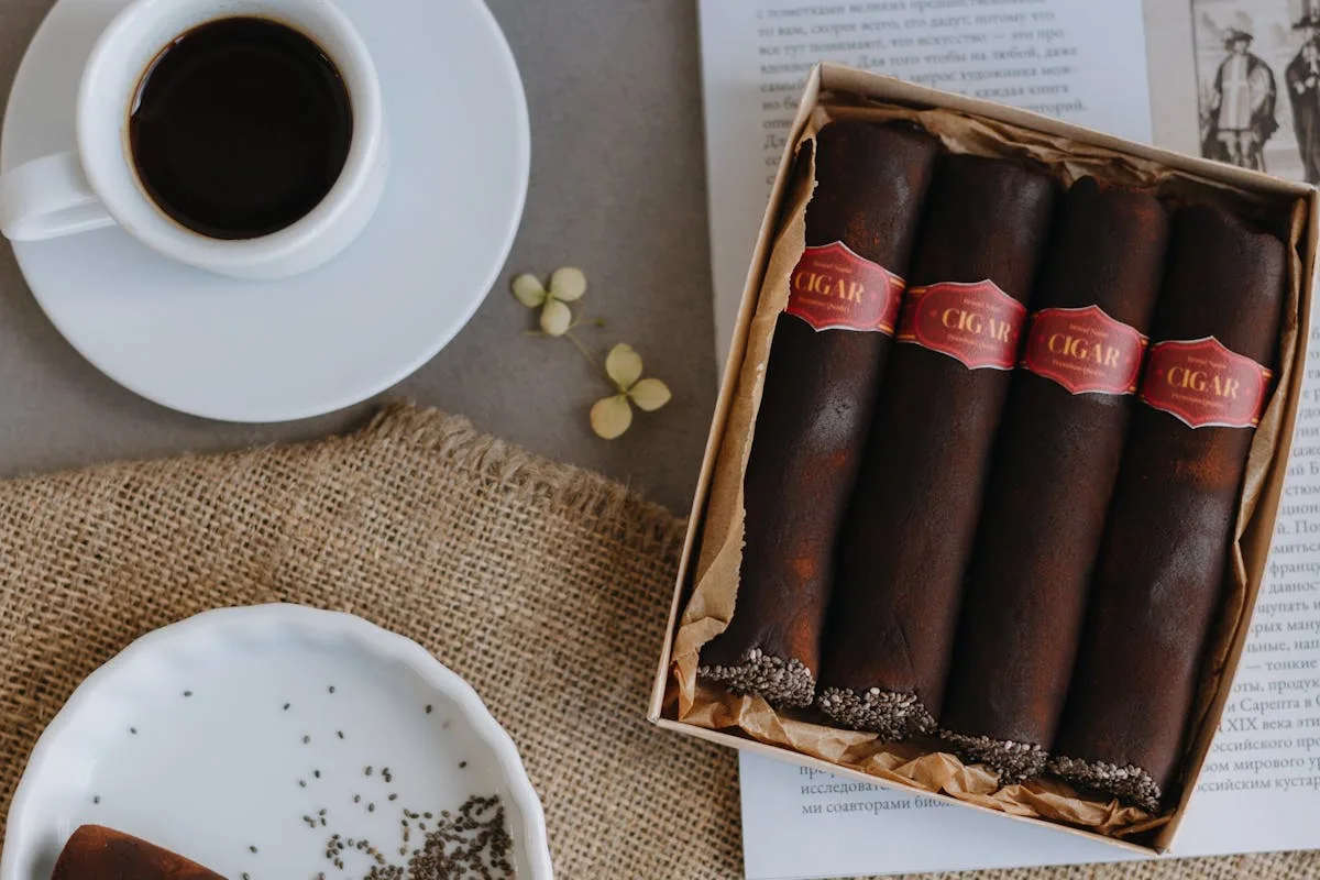 Top view of a coffee cup with chocolate cigars on a table for a relaxed gourmet setting