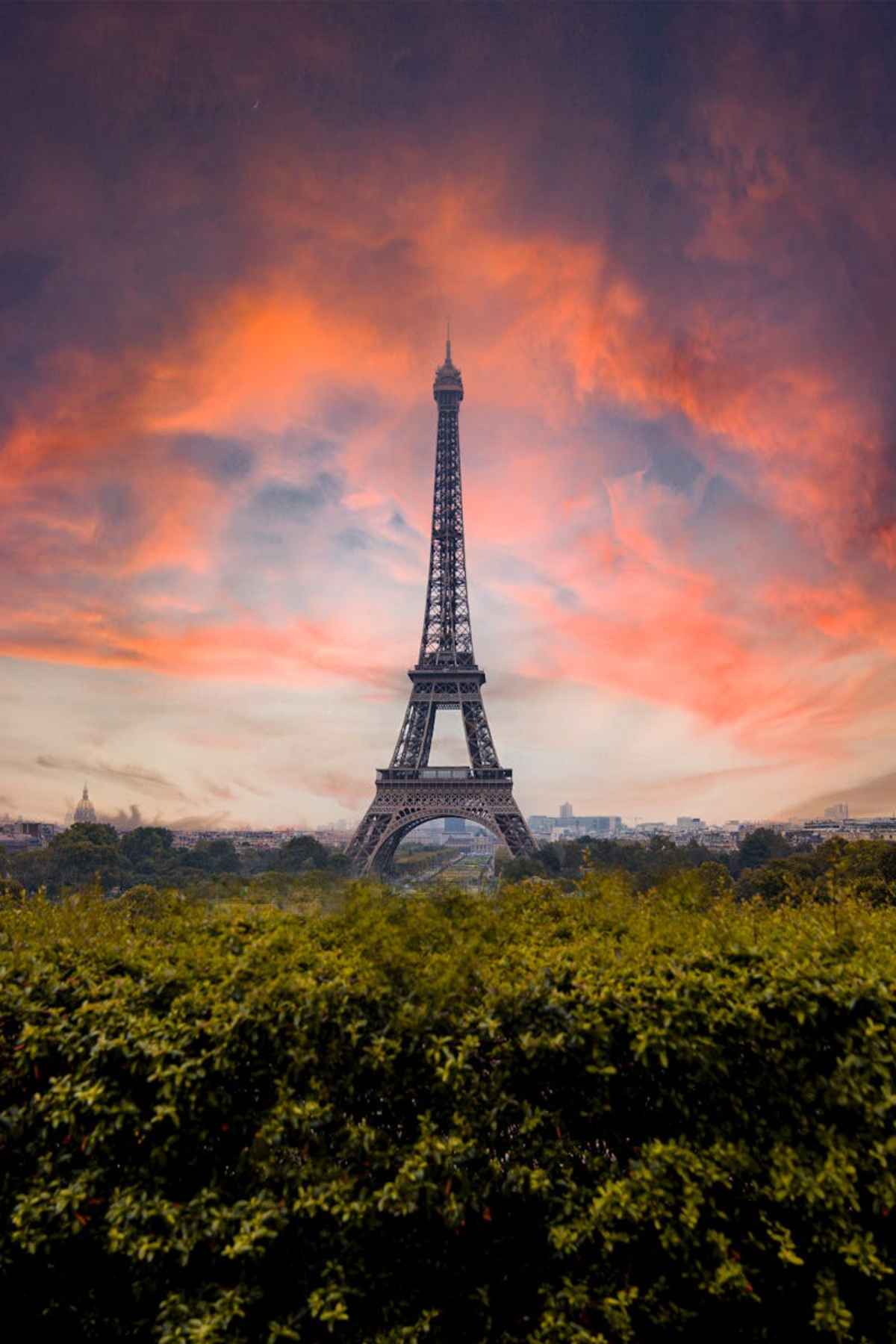 Day Trips From Paris to Normandy: Exploring Historic and Scenic Gems 2 Stunning view of the Eiffel Tower against a dramatic sunset sky in Paris