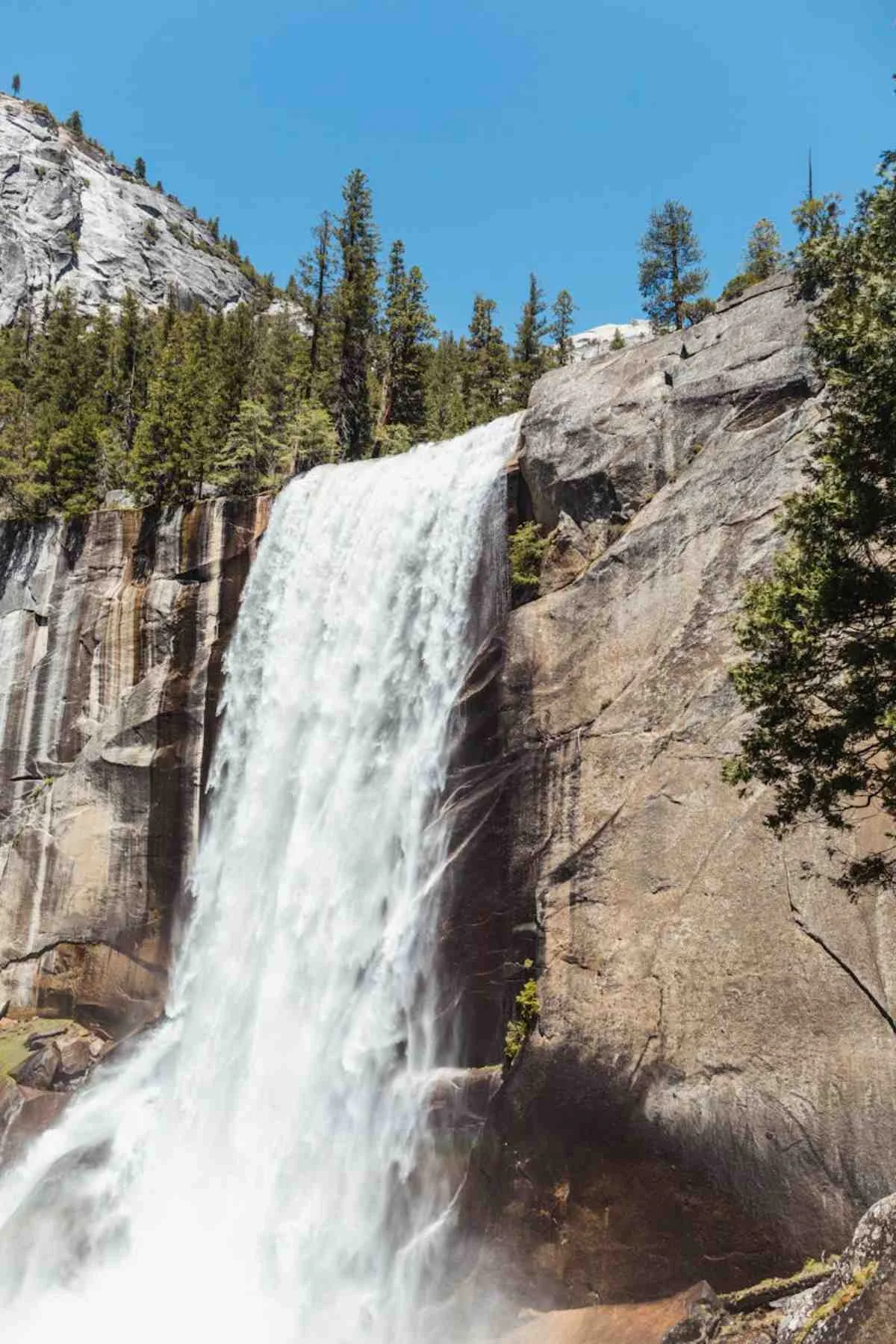 Vernal Falls cascading down rocky cliffs in Yosemite national park