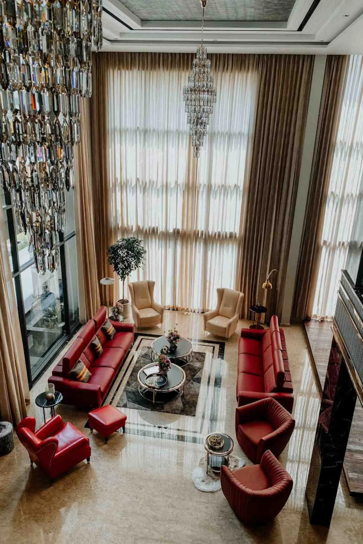 Lavish modern living area featuring chandeliers luxurious seating and elegant decor