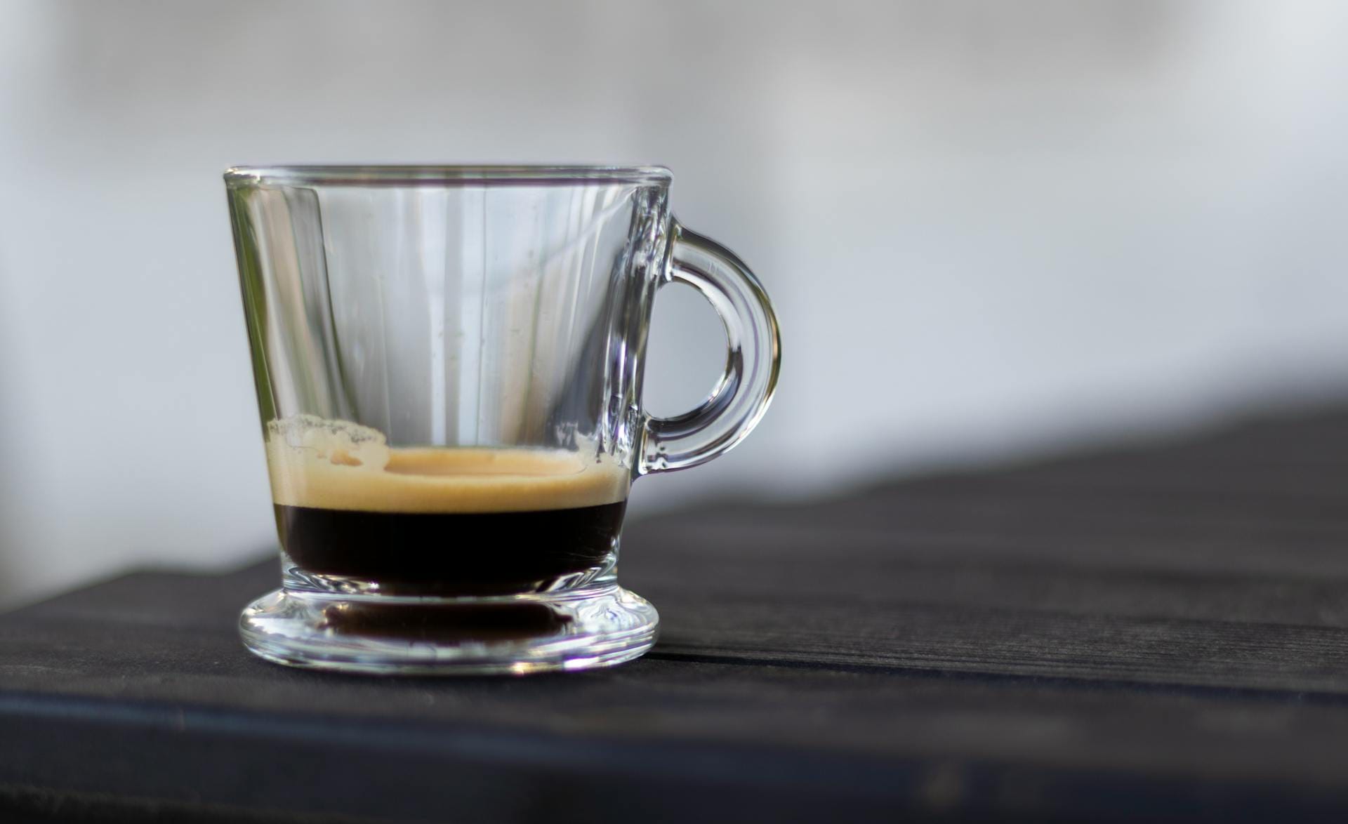 gibraltar coffee vs cortado espresso drink in a clear glass cup on dark table
