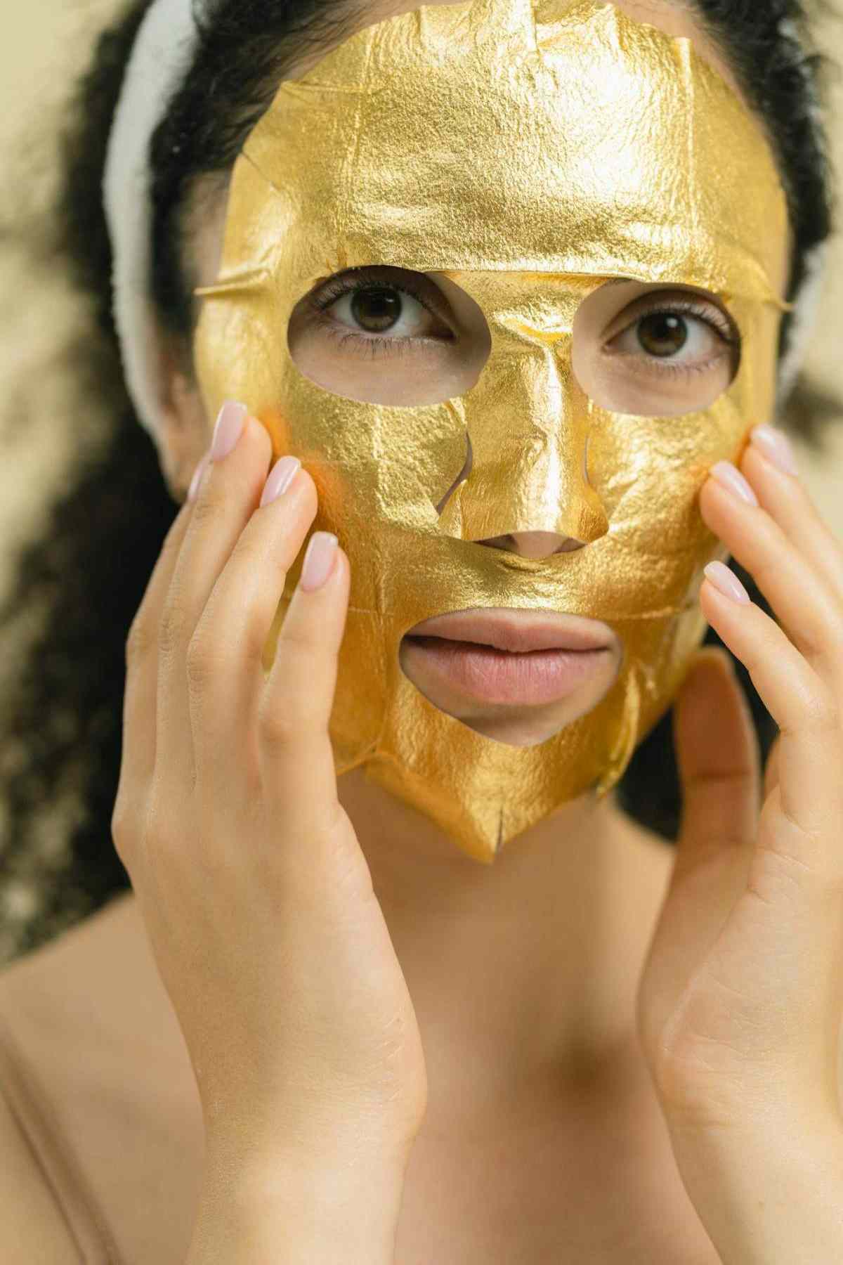 Gold 24k facial treatment being applied with brush at luxury spa
