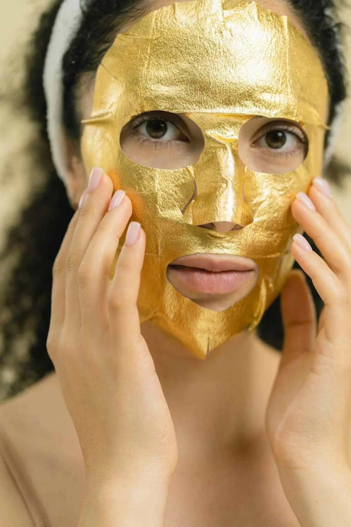 Gold 24k facial treatment being applied with brush at luxury spa