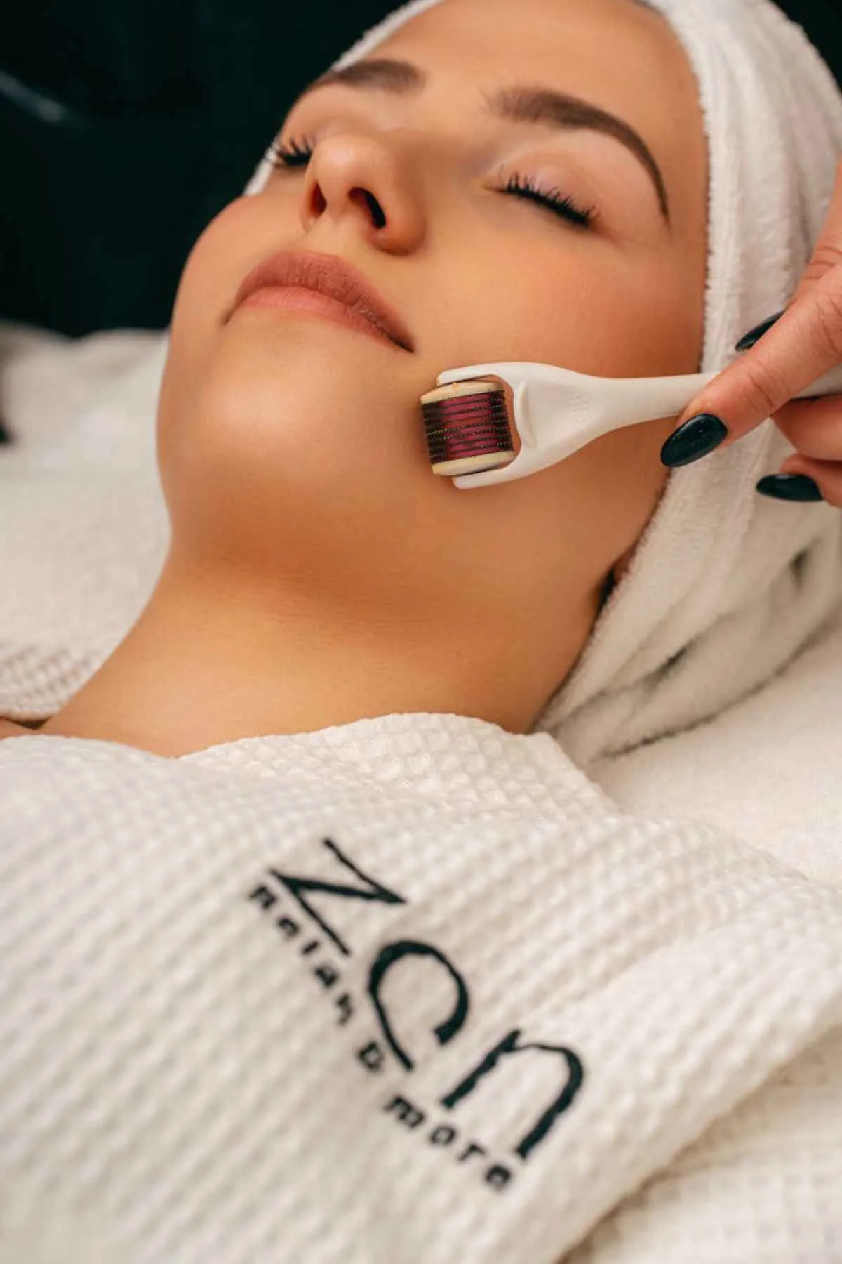 Close-up of a woman enjoying a relaxing facial massage in a tranquil spa