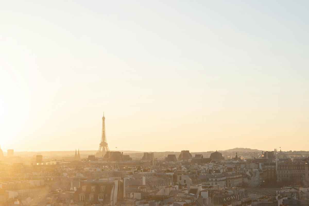 Luxury Gifts from Paris: Exquisite Finds for Every Occasion 1 A tranquil aerial view of the Eiffel Tower at sunset, overlooking the Parisian rooftops.