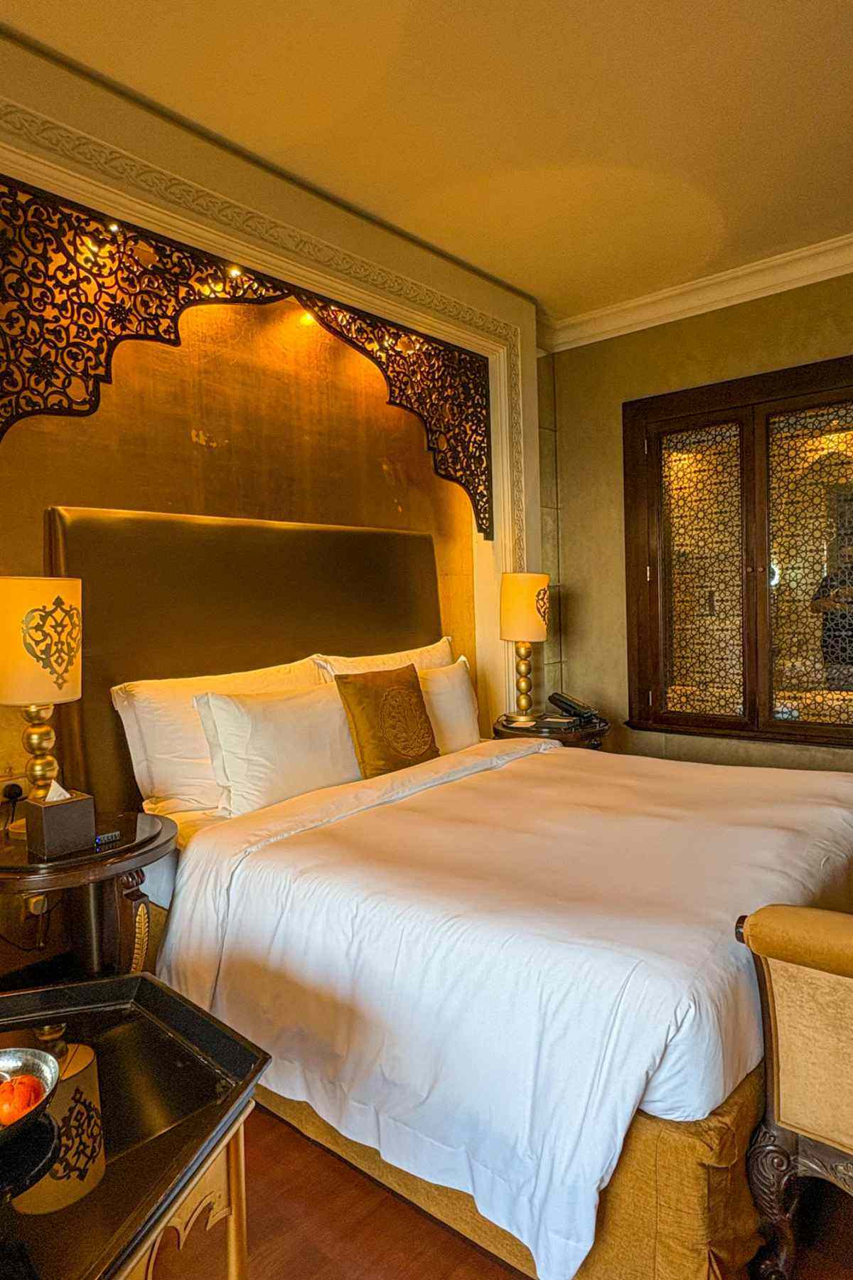 Magellan luxury hotel room with warm gold tones and elegant bedroom decor