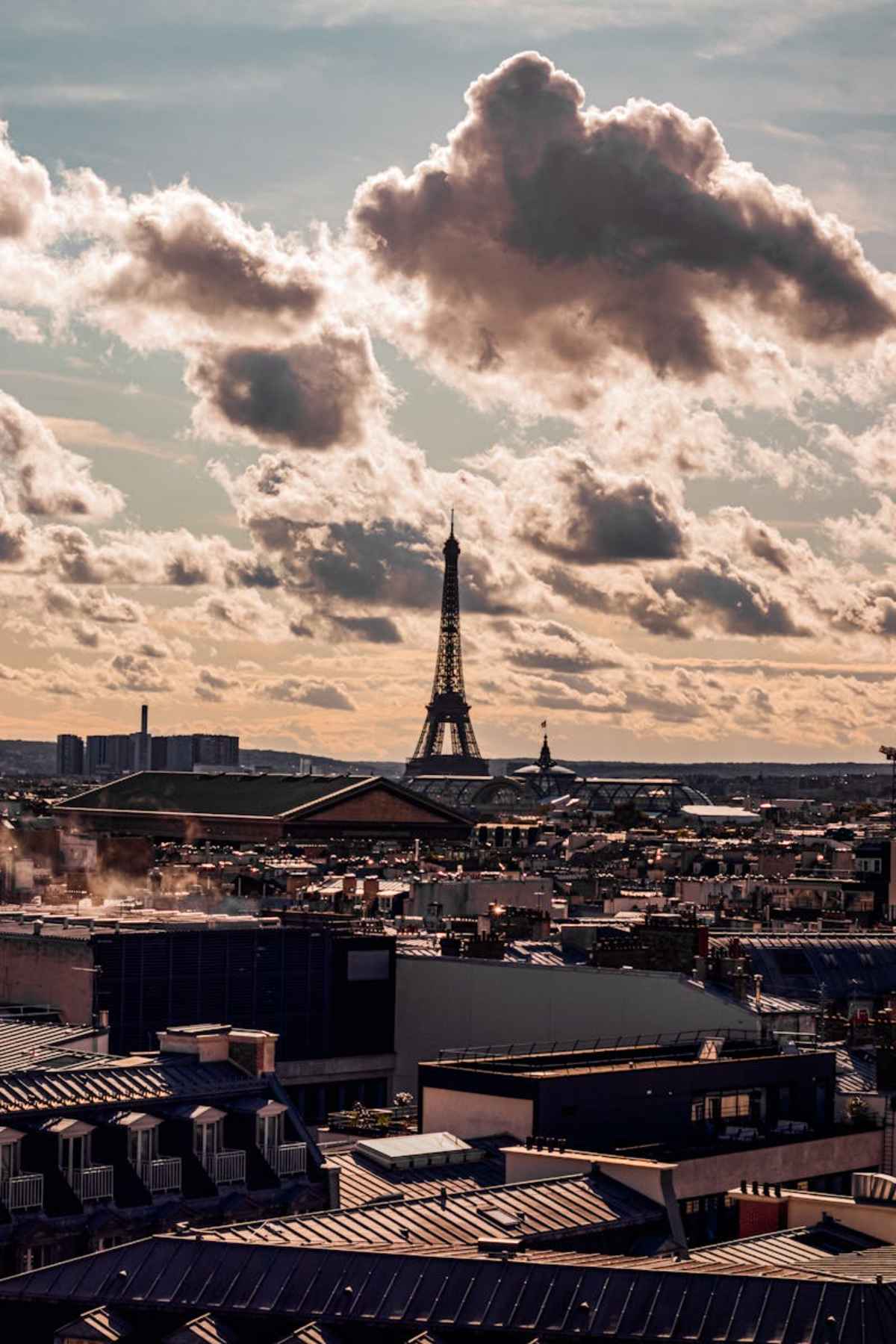 Scenic view of Eiffel Tower against a dramatic sunset sky in Paris