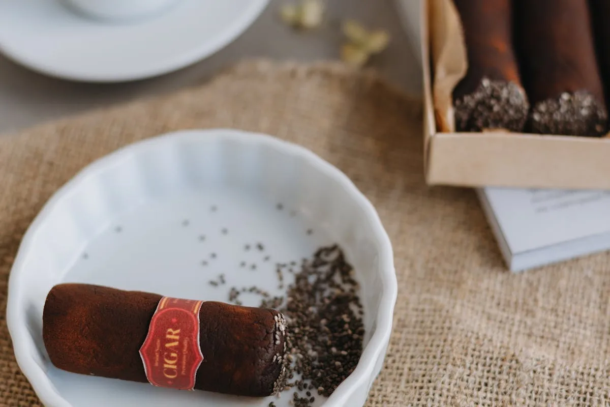 Classic pairing of espresso and premium cigars arranged on a natural burlap surface