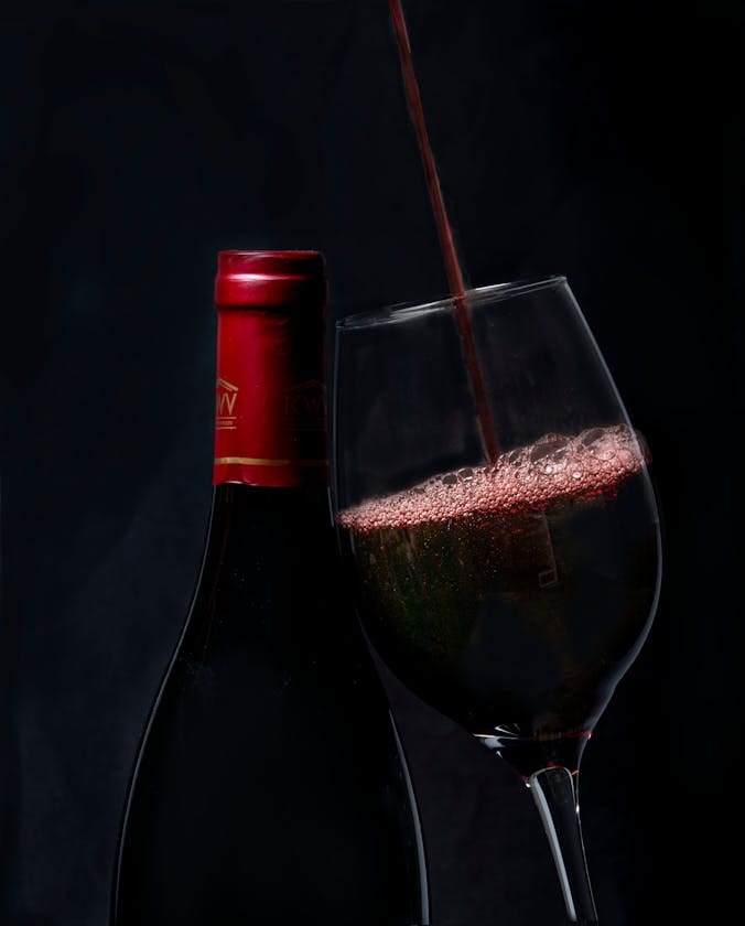 red wine being poured into glass zinfandel merlot pairing