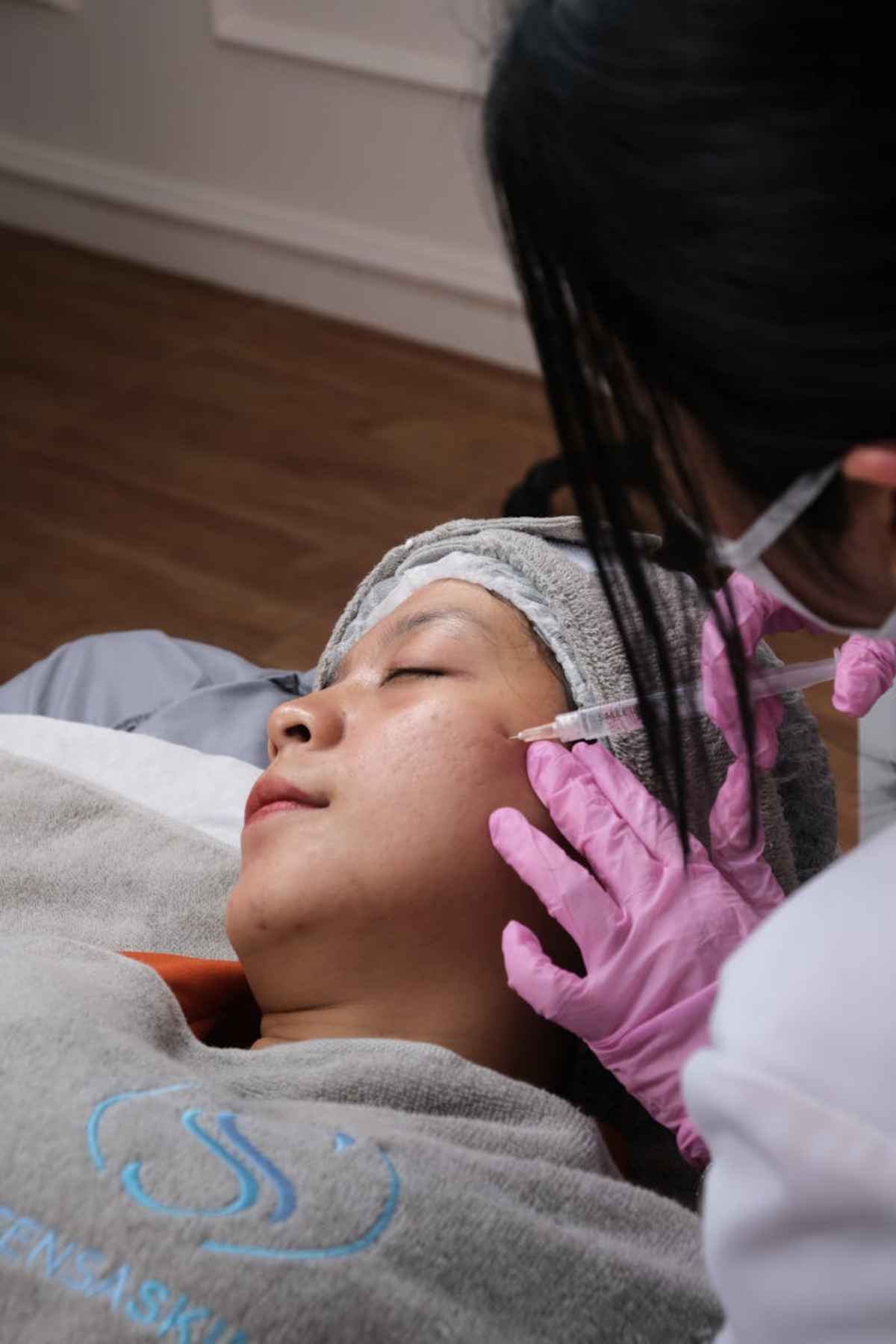 Aesthetic treatment being administered in a clinic setting professional care