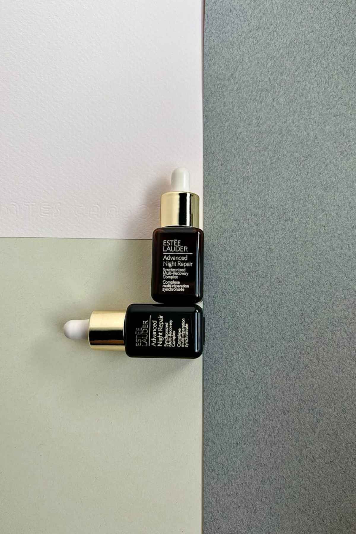 Luxury serum vials on textured background skincare cosmetics