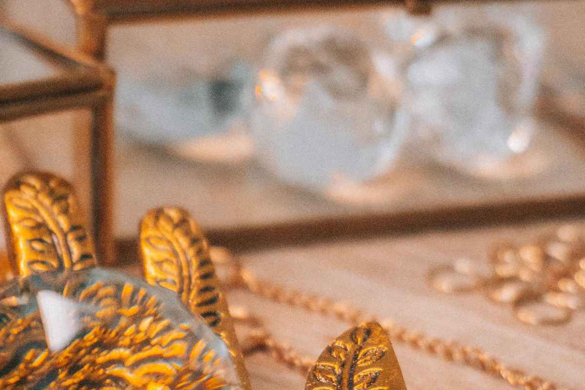 Beautiful arrangement of glass crystals and gold ornament on a tray, perfect for decor inspiration.