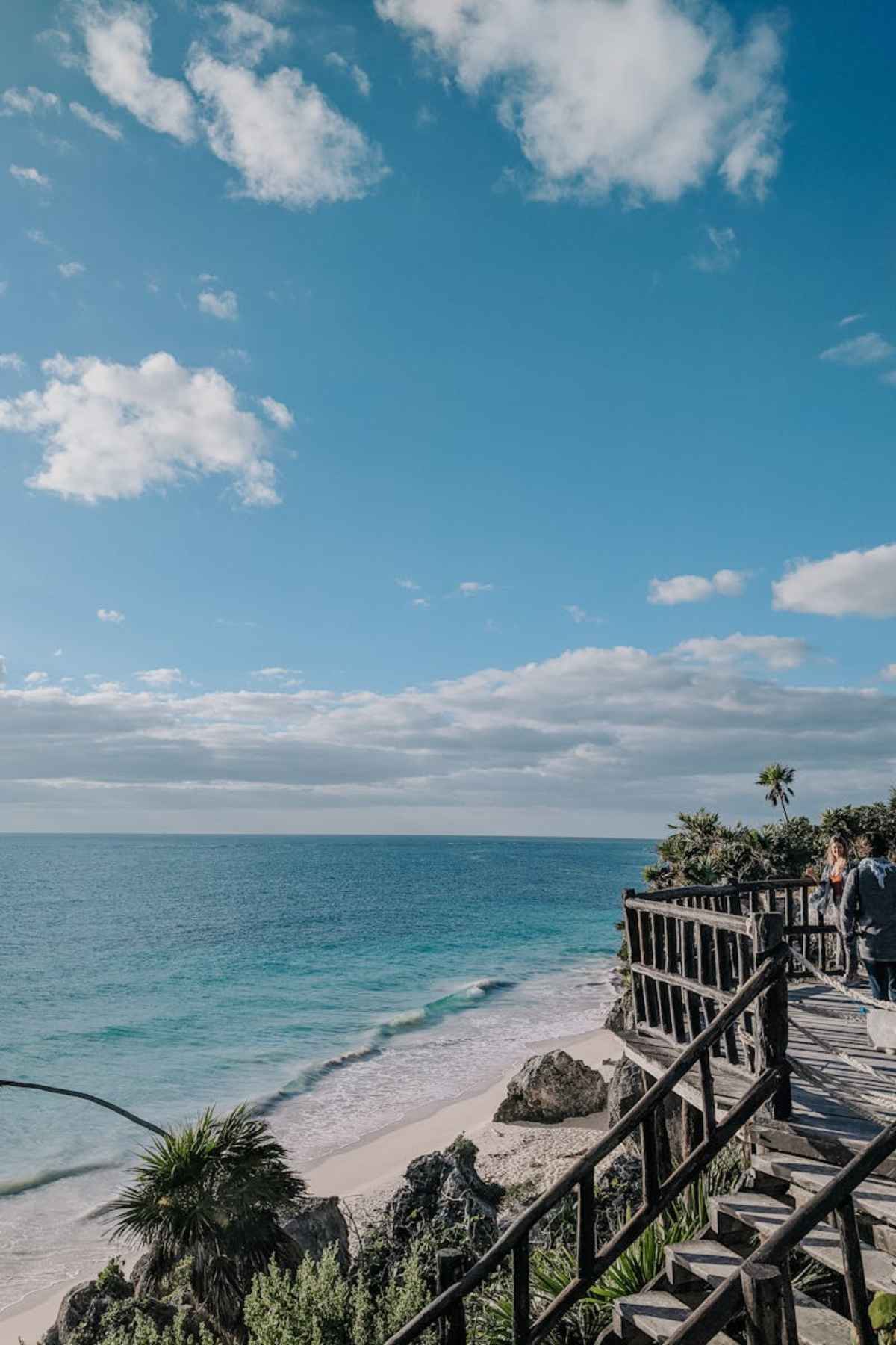 Stunning turquoise waters and sandy beach from wooden walkway Tulum Mexico