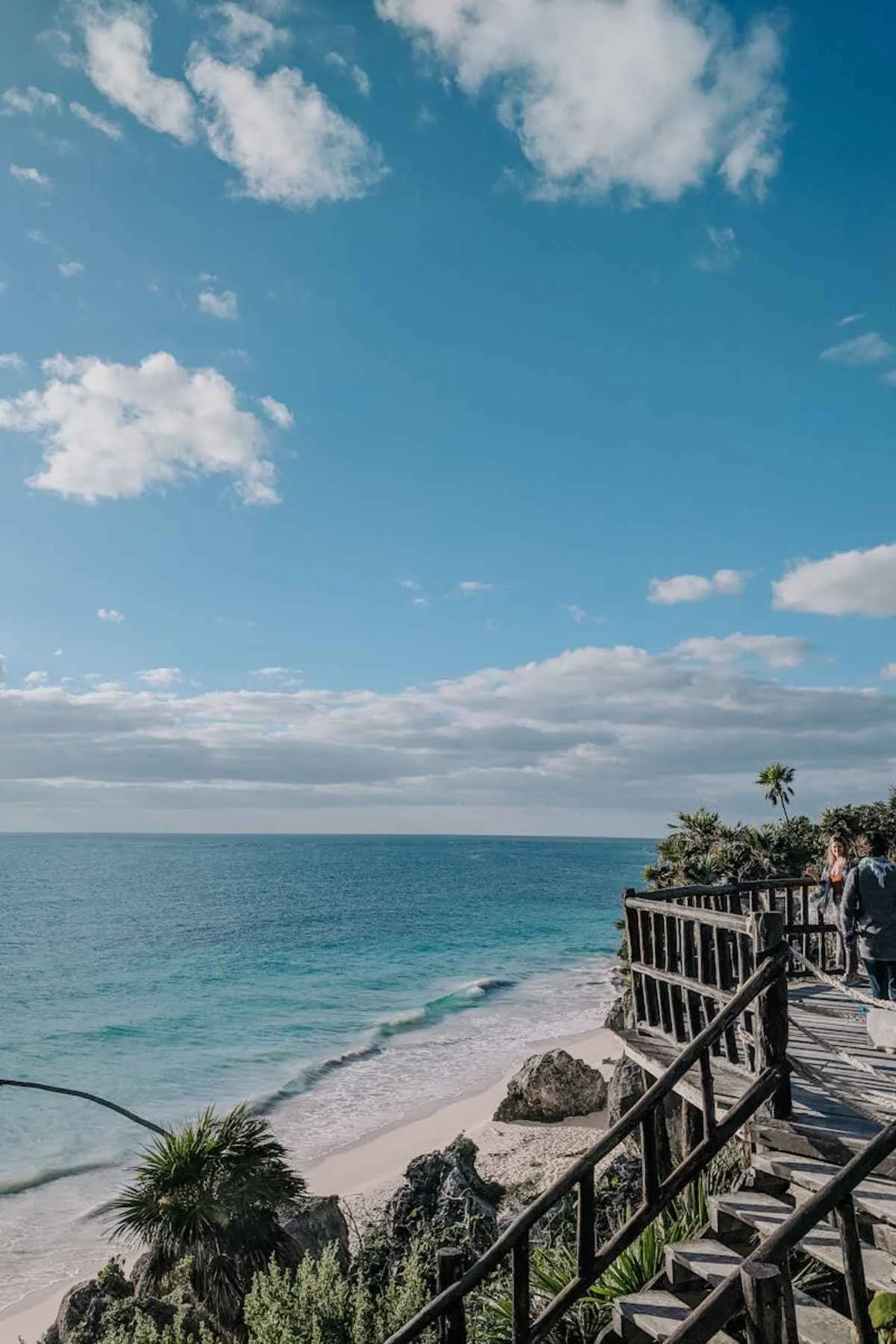 Stunning turquoise waters and sandy beach from wooden walkway Tulum Mexico