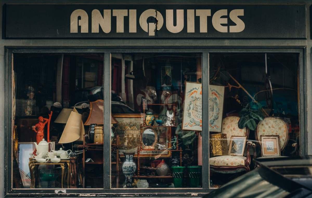 Luxury Gifts from Paris: Exquisite Finds for Every Occasion 2 Luxury gifts from Paris for the home: antiques shop window with vintage decor, lamps and tableware