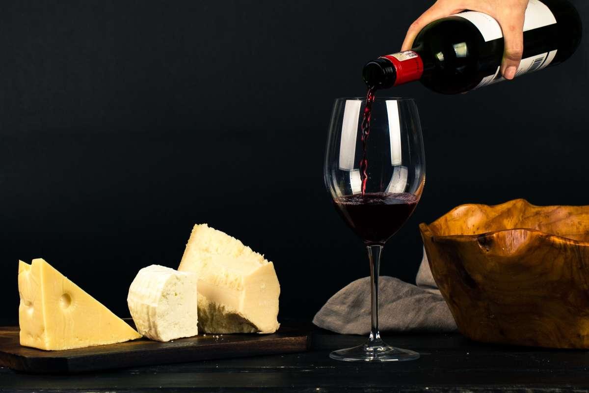 Types of Wine: 5 Main Styles You Need to Know First 4 Red wine poured into a glass beside a board of hard and soft cheeses