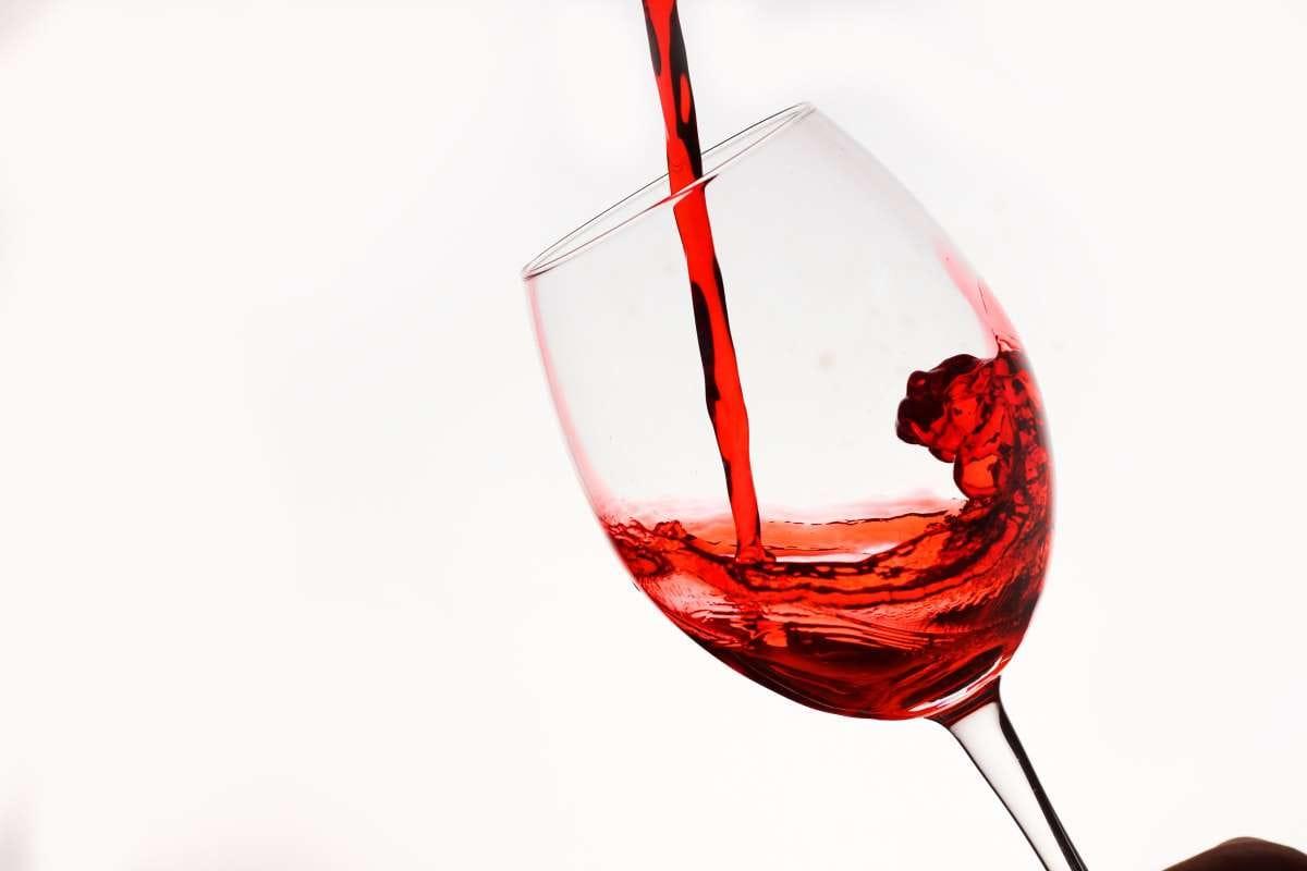 Types of Wine: 5 Main Styles You Need to Know First 1 Red wine pouring into a glass against a white background