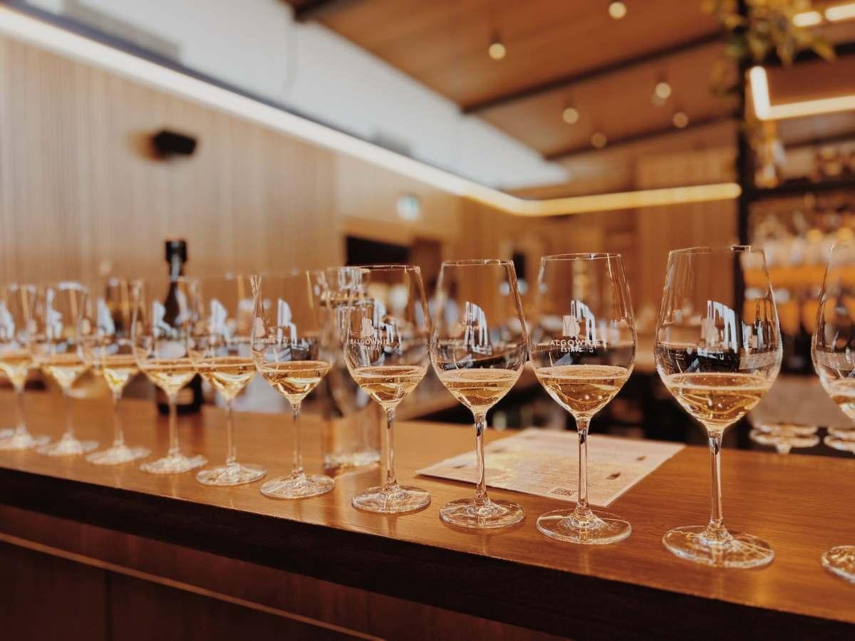 Wineries Springfield MO: Best Local Gems to Visit 1 White wine glasses lined up along a wooden tasting bar