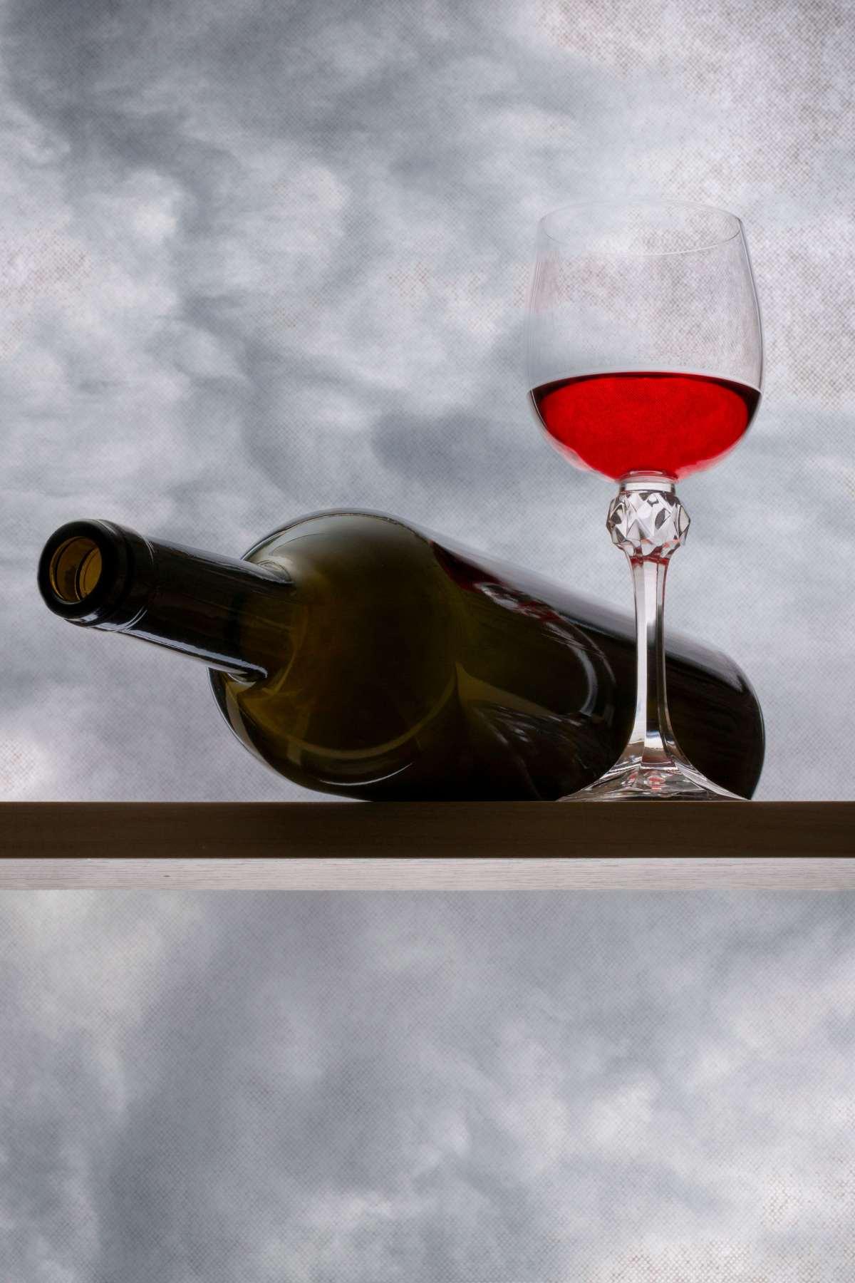 What Temperature to Store Red Wine: The 55°F Storage Guide 13 Bottle of red wine and a glass of red wine on a wooden storage shelf